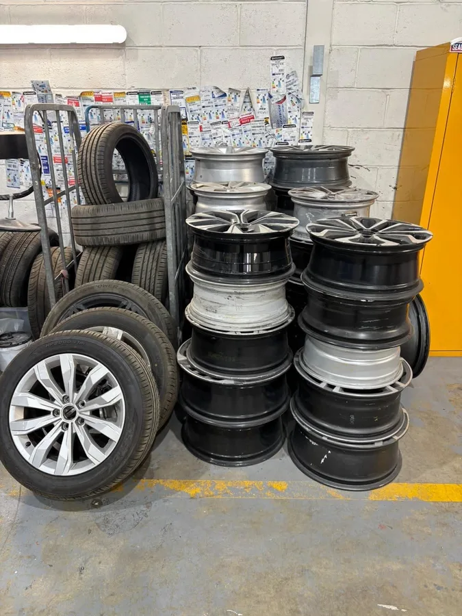 Stacked alloy wheels ready for collection