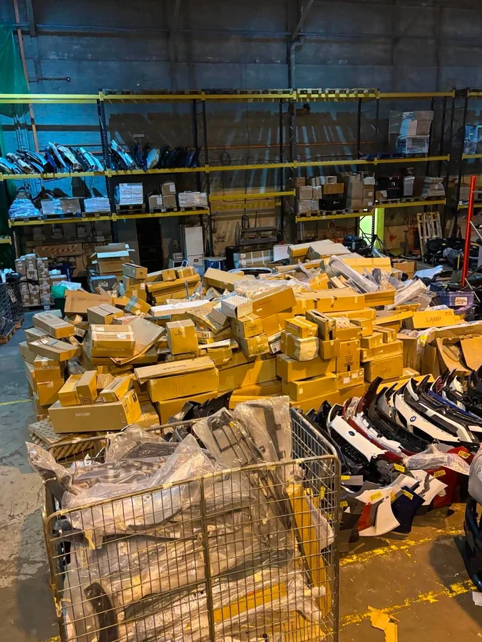 Boxed unused genuine automotive parts in storage